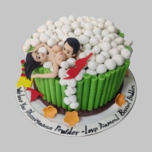 3D cake of a couple in a green bubble bath tub with white fondant bubbles. Funny and romantic custom anniversary cake delivery in Hyderabad, Banjara Hills, and Jubilee Hills.