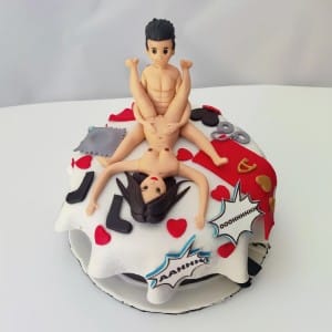 Funny adult bachelor party cake featuring 3D couple figures on a bed with comic book sound bubbles. Naughty Kama Sutra cake delivery in Hyderabad, Banjara Hills, and Jubilee Hills.